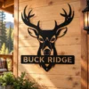 Custom deer buck antlers metal sign personalized with a name, featuring laser-cut hunting wall art for rustic cabins, lodges, garages, and man caves.