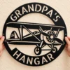 Custom Vintage Biplane Metal Sign Personalized Grandpa Hangar Pilot Decor Custom vintage biplane metal sign personalized with Grandpa or pilot name, classic airplane wall decor for hangars, garages, aviation offices and pilot gifts.
